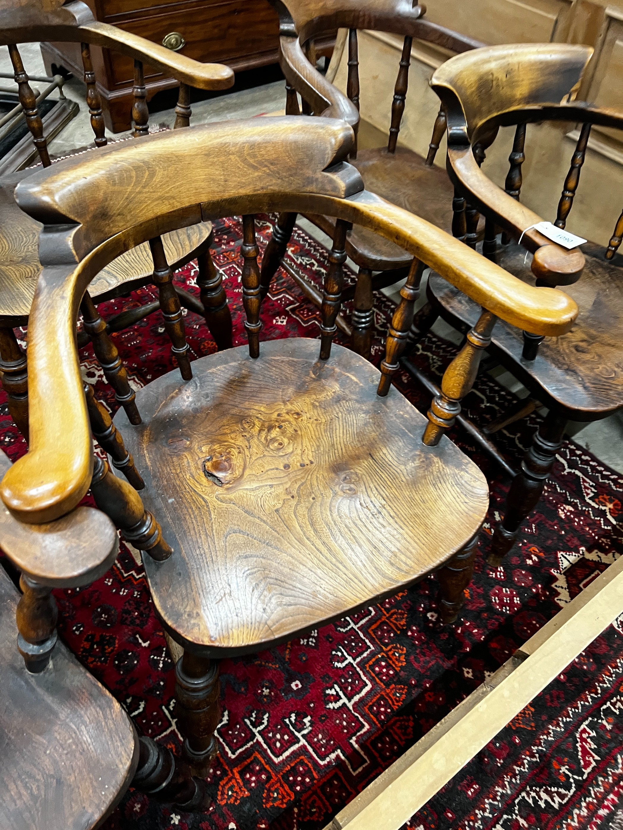 A harlequin set of five Victorian elm and beech smoker's bow chairs